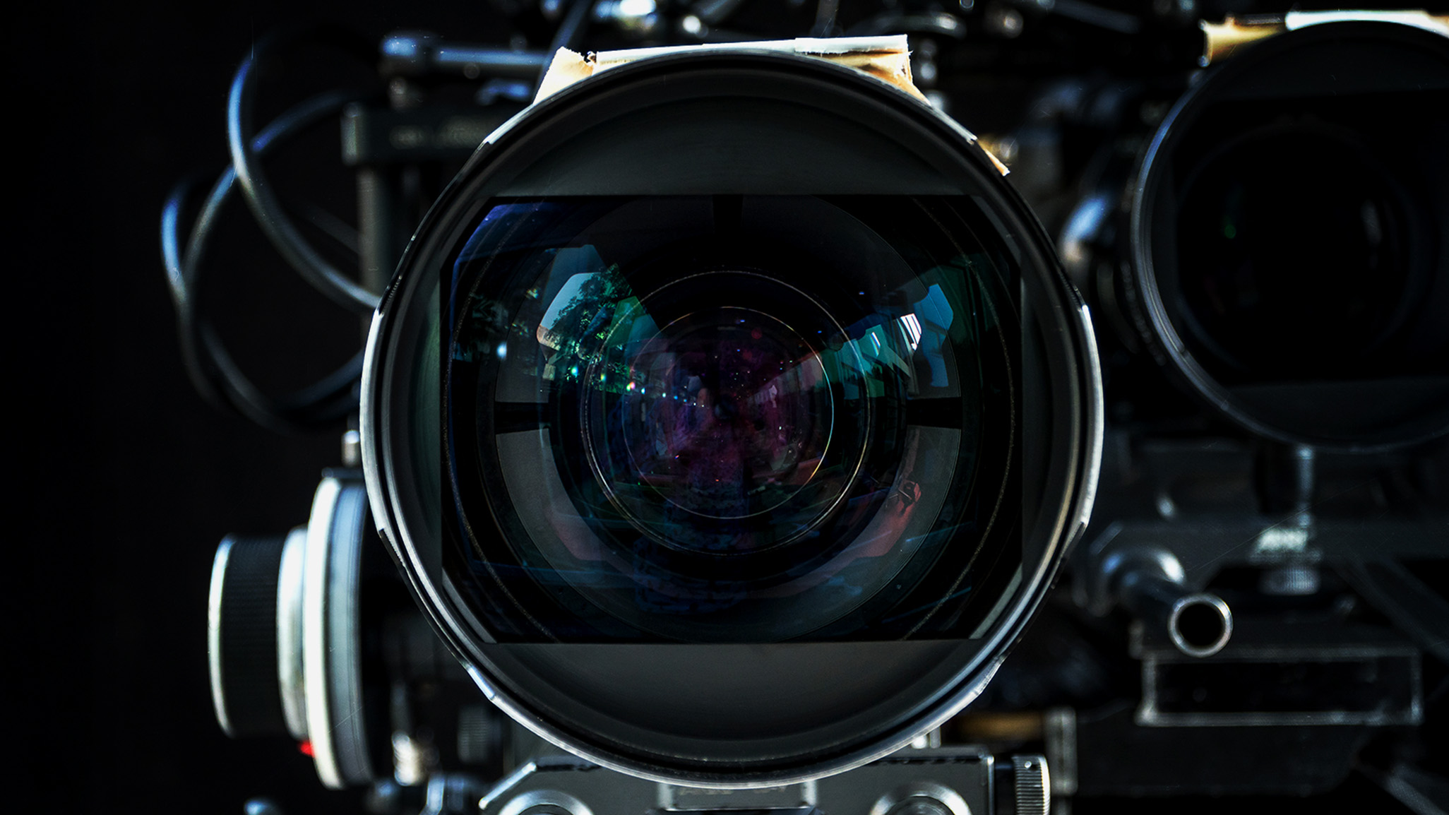 Front view of a cinema-camera lens. Illustrative photograph from the supplied vault.